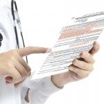 Close up of a woman doctor hand touching tablet pc
