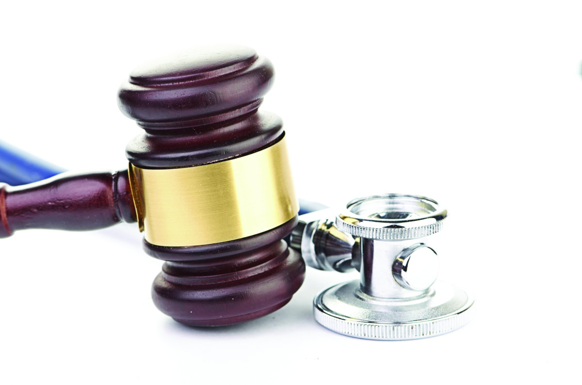brown gavel and a medical stethoscope