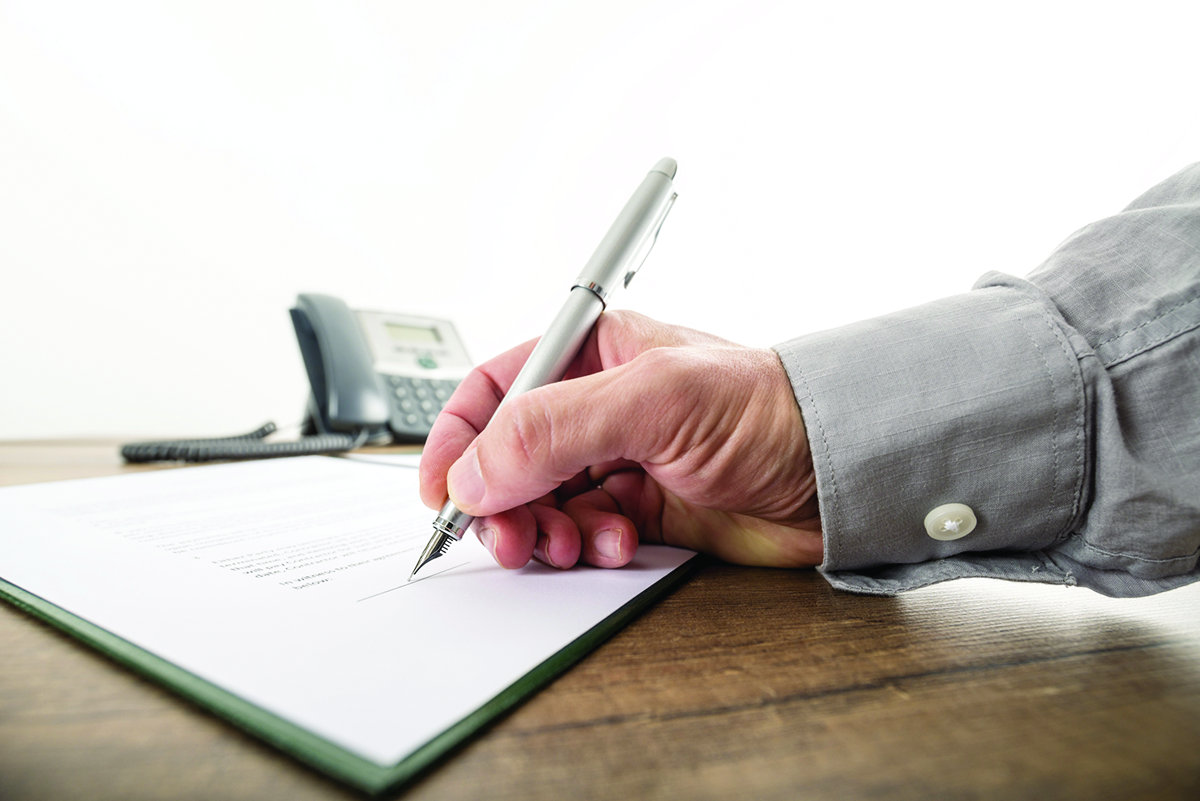 Closeup of businessman or lawyer signing an important contract,