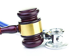 brown gavel and a medical stethoscope