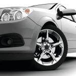 Car front bumper, light and wheel on white. Detail
