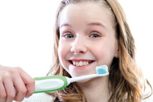 Happy girl about to brush teeth.