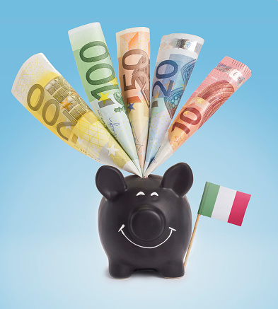 Various european banknotes in a happy piggybank of Italy.(series